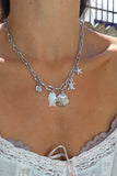 Silver clam shell and charm necklace