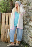 Pink whipstitch and cream cardigan