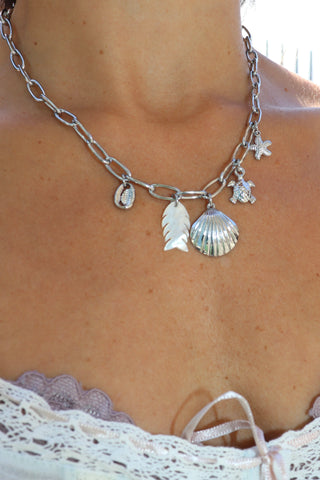 Silver clam shell and charm necklace