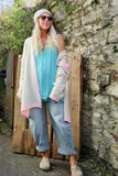 Pink whipstitch and cream cardigan