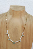 White bead necklace with blue tear drop bead