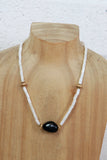 White beaded necklace with black stone